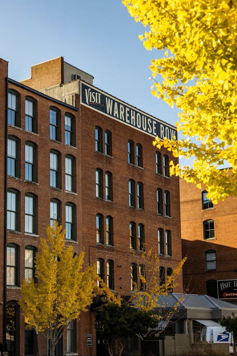 Brick warehouse building with autumn trees in front