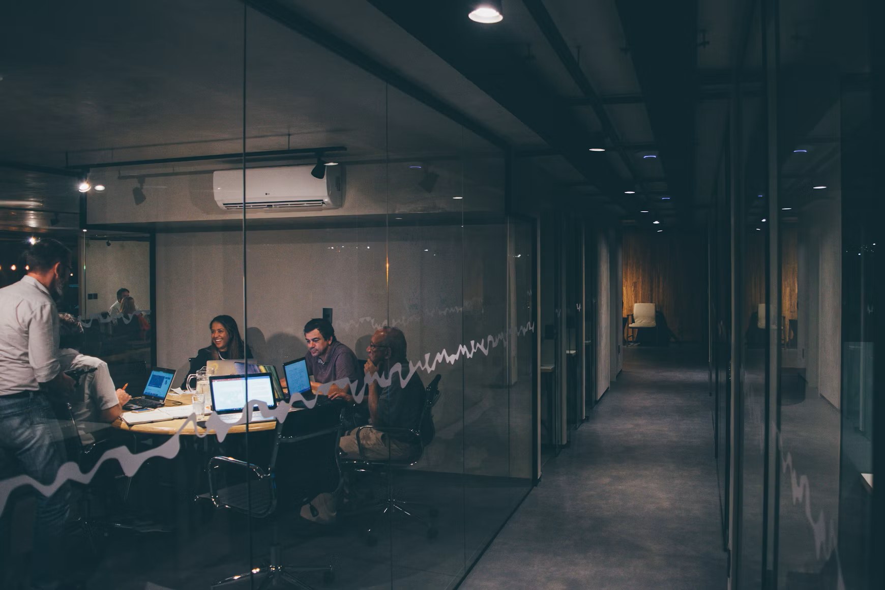 A small team working late around one conference table